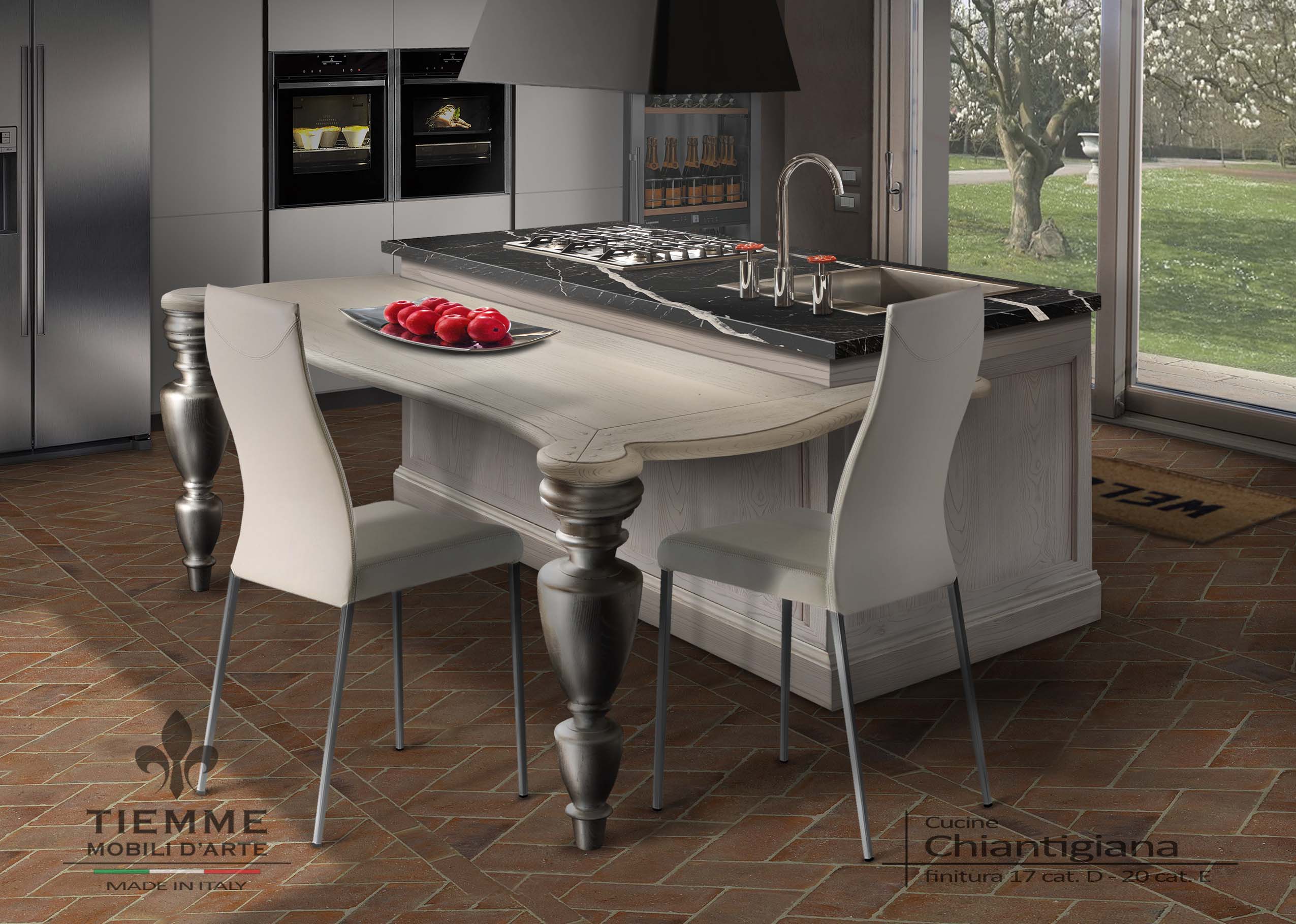 Cucina con cottura e lavello a isola, Chiantigiana. Cucina a isola centro stanza costruita in frassino, con piano di marmo nero Marquinia nella zona operativa della cottura e del lavello.
